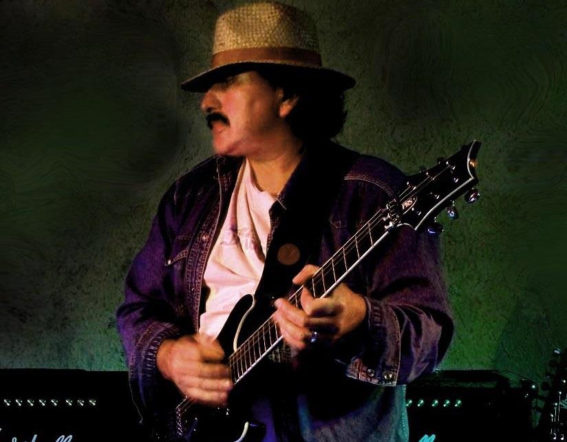Chris Dair performing with a guitar
